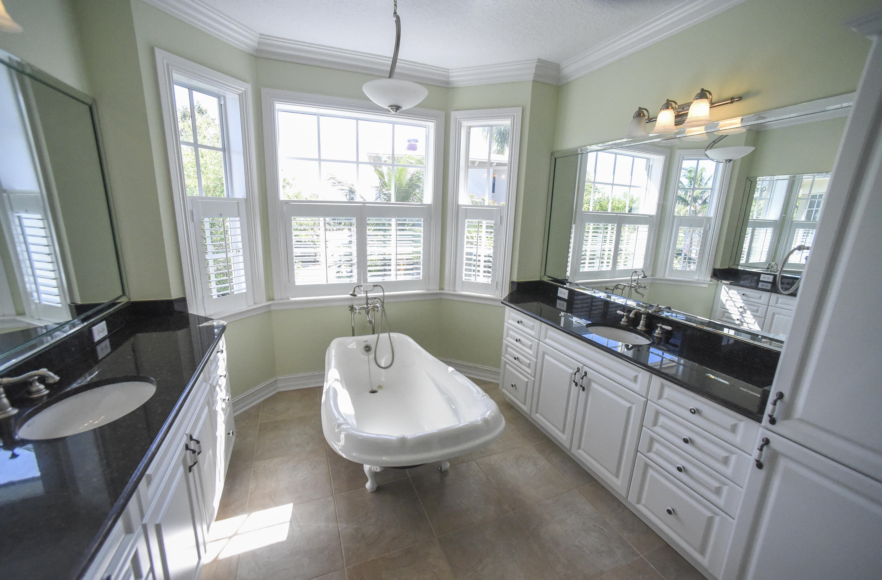 552 Southwest St Lucie Crescent Stuart, FL 34994 - Photo 15 of 36 a large bathroom with a tub sink and mirror