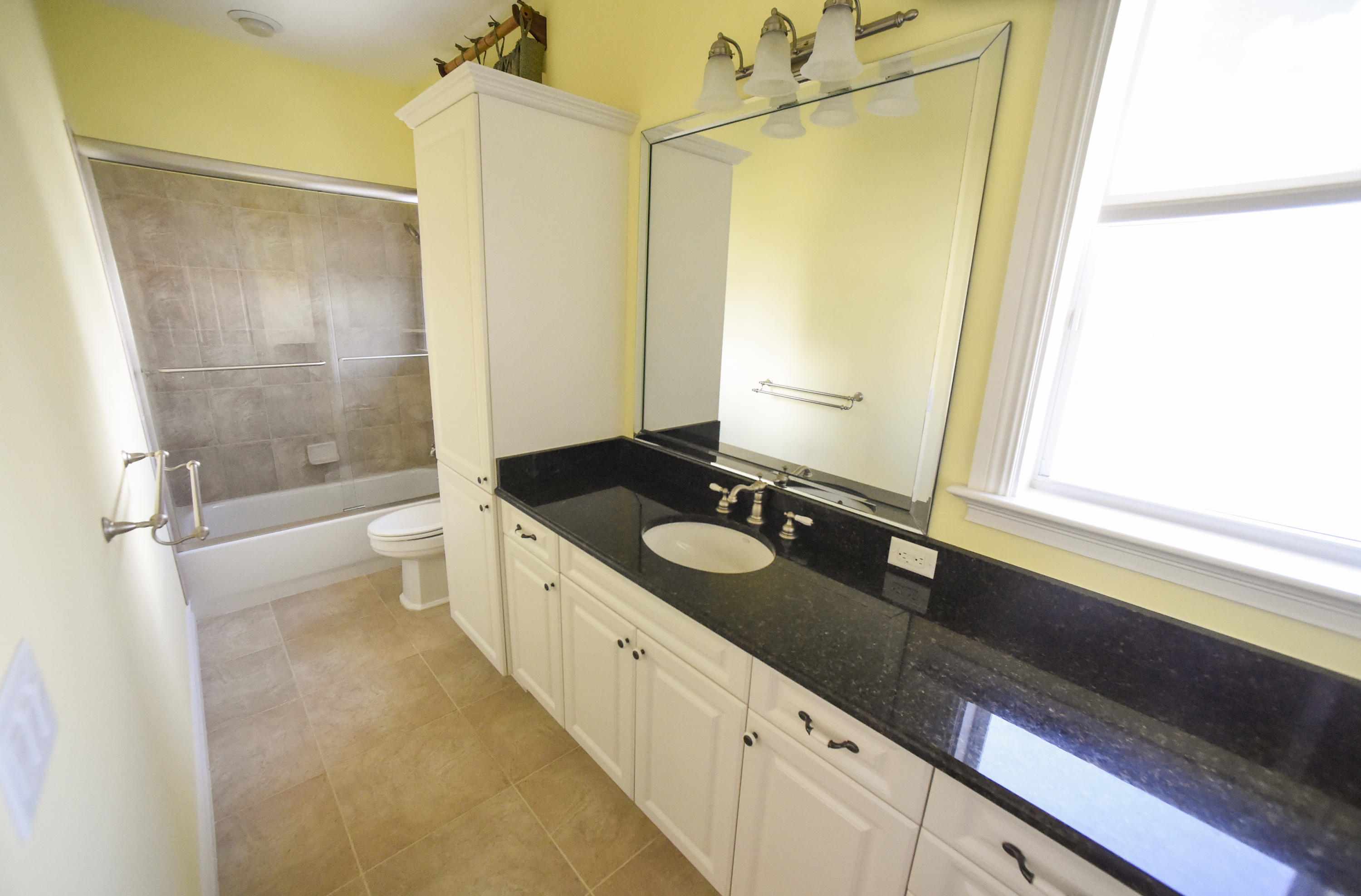 552 Southwest St Lucie Crescent Stuart, FL 34994 - Photo 18 of 36 a spacious bathroom with a granite countertop sink mirror and a bathtub