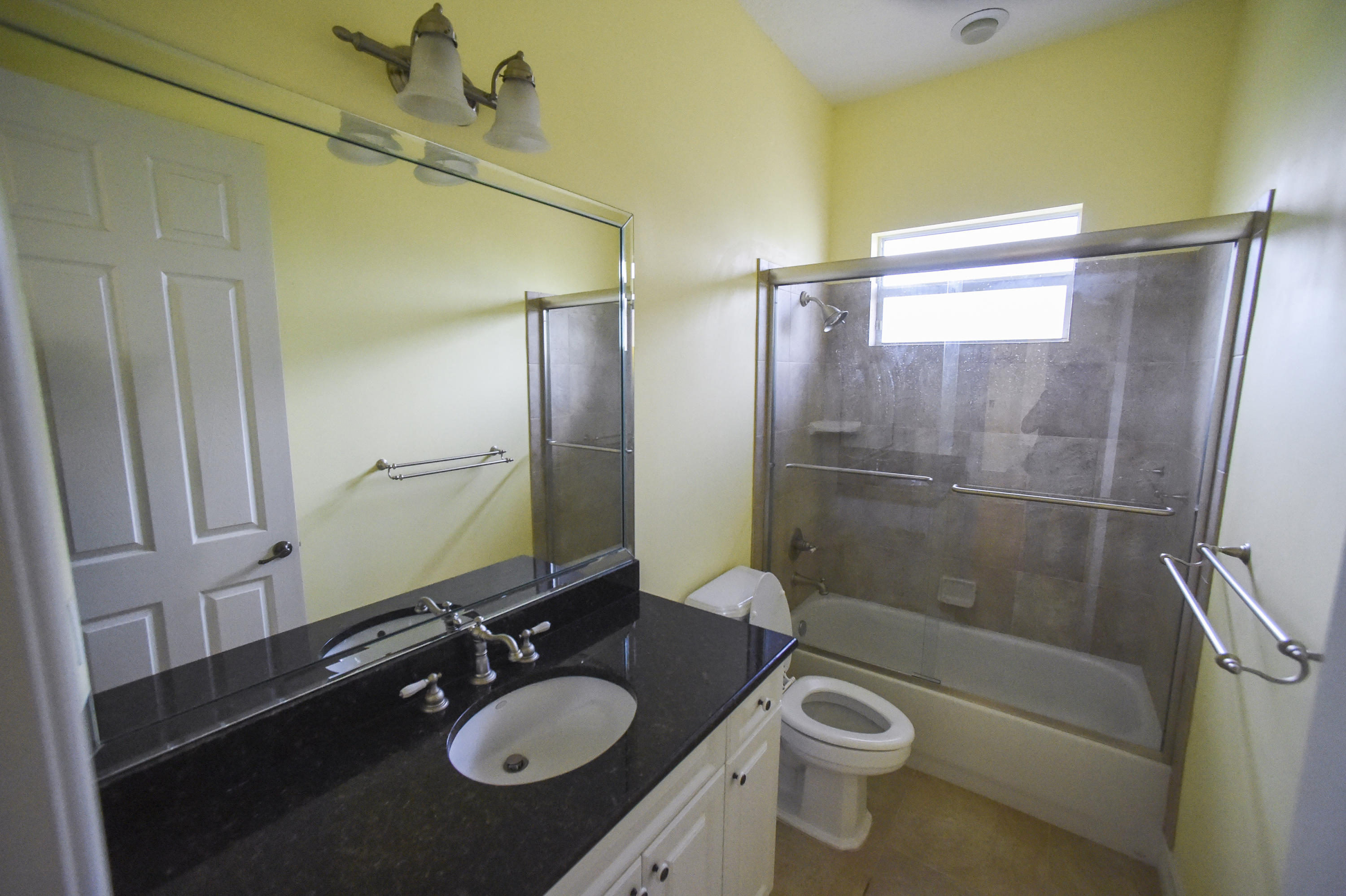 552 Southwest St Lucie Crescent Stuart, FL 34994 - Photo 20 of 36 a bathroom with a sink a toilet and shower