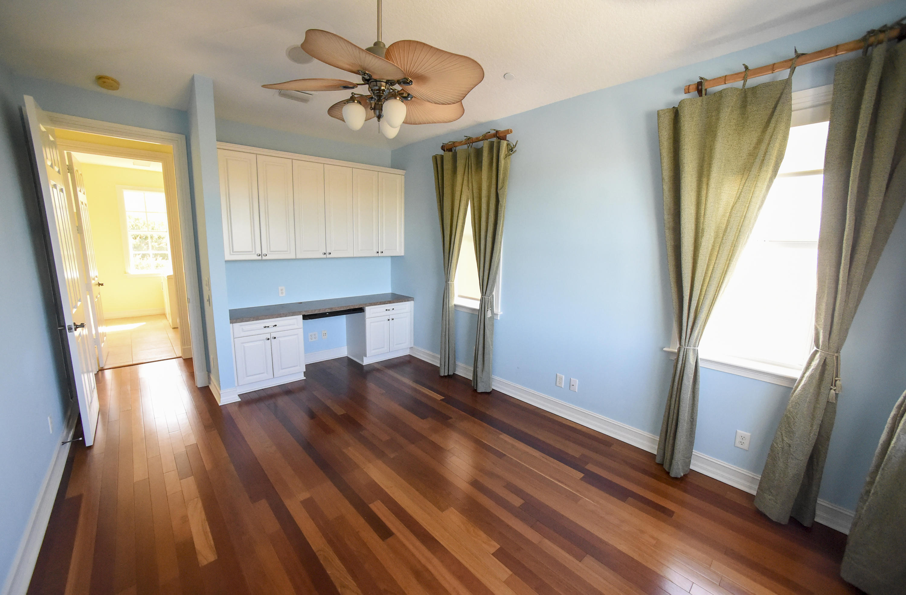 552 Southwest St Lucie Crescent Stuart, FL 34994 - Photo 23 of 36 a view of empty room with wooden floor and fan