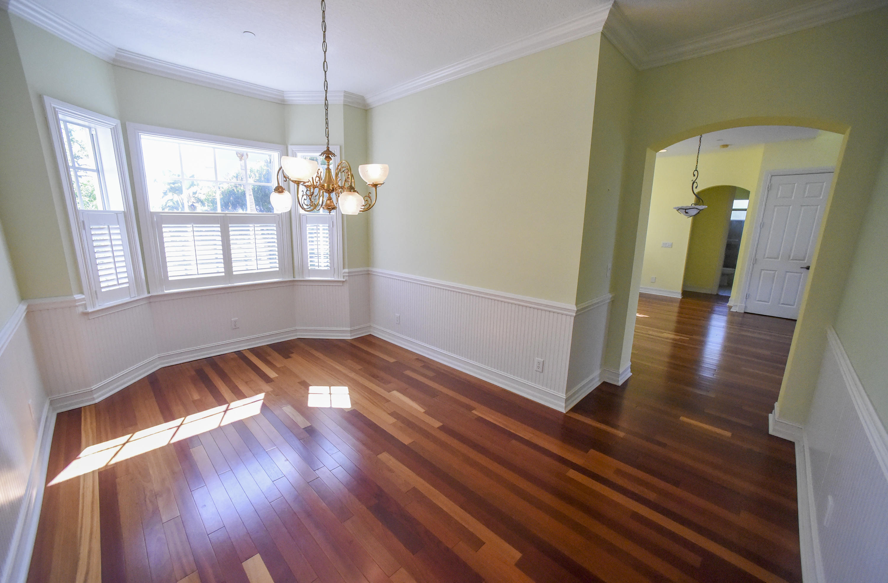 552 Southwest St Lucie Crescent Stuart, FL 34994 - Photo 4 of 36 a view of empty room with wooden floor and fan