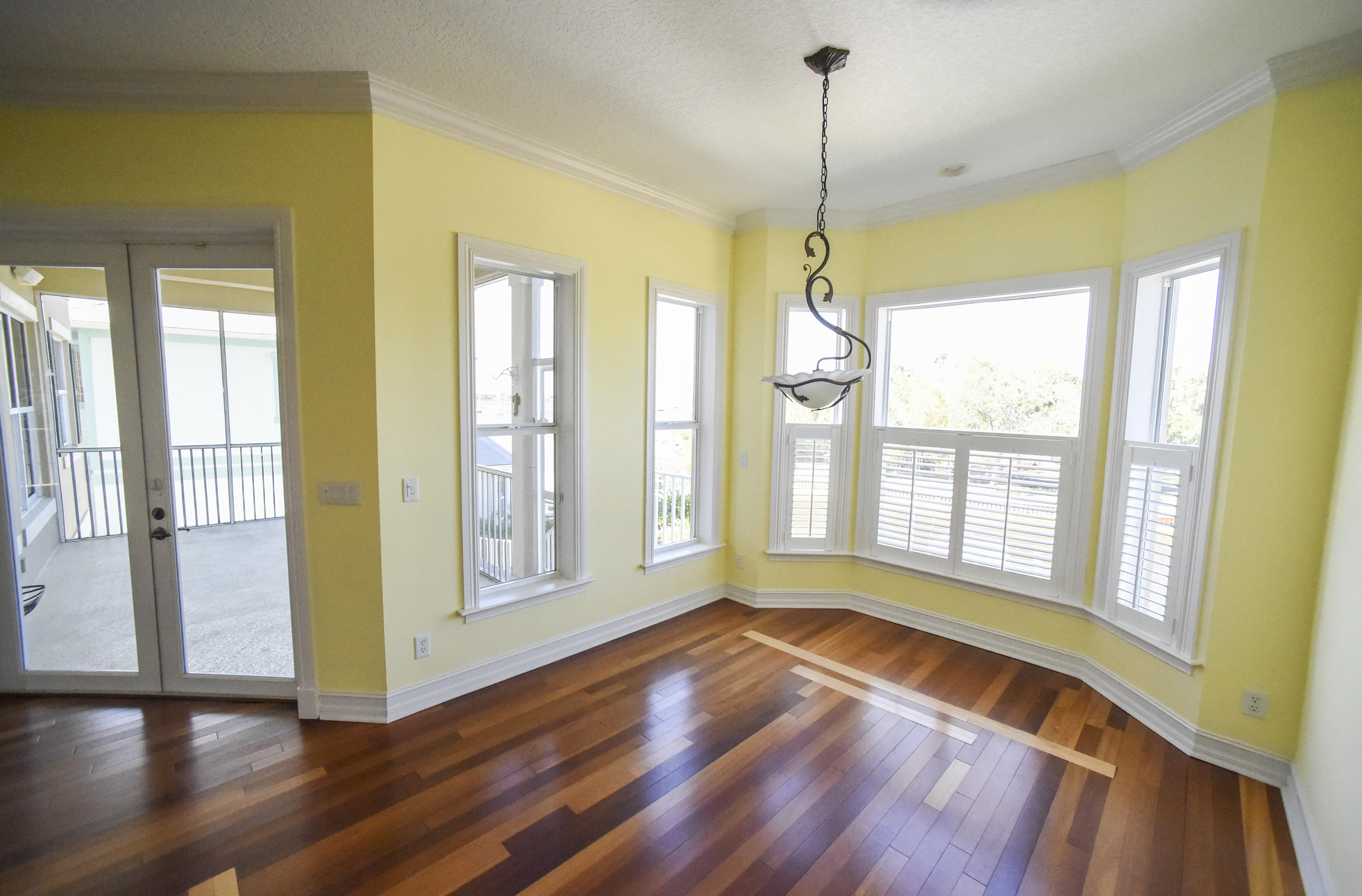 552 Southwest St Lucie Crescent Stuart, FL 34994 - Photo 8 of 36 a view of an empty room with glass door and wooden floor