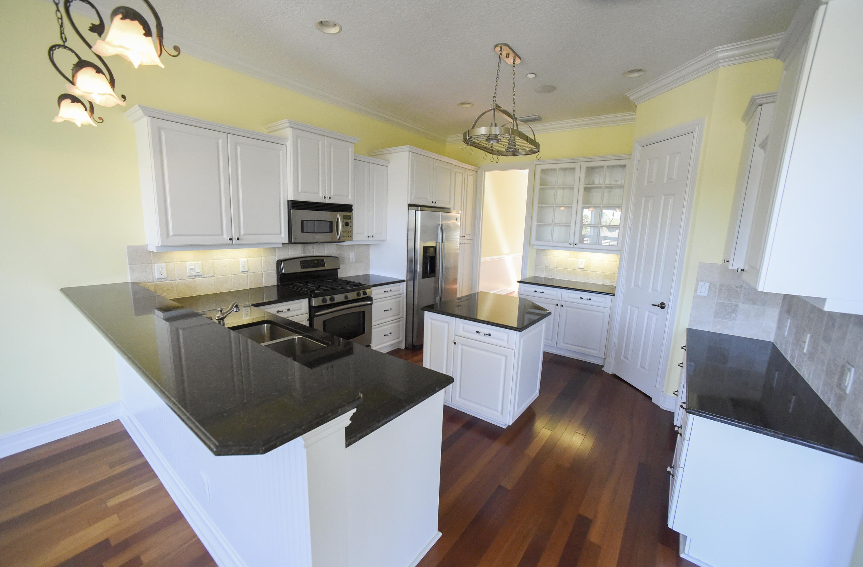 552 Southwest St Lucie Crescent Stuart, FL 34994 - Photo 10 of 36 a kitchen with stainless steel appliances granite countertop a sink stove and refrigerator
