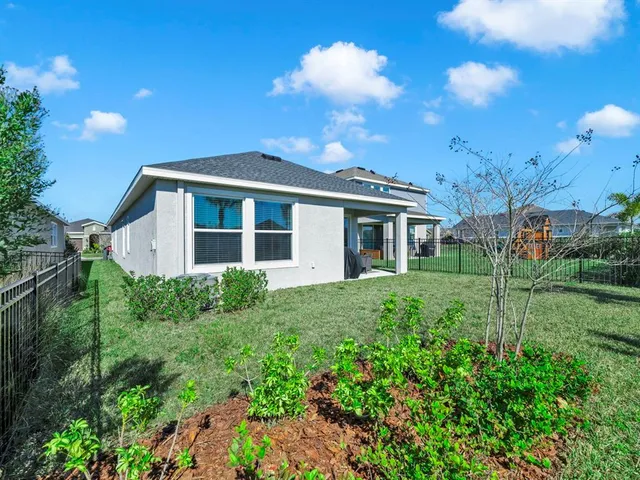 a view of a house with yard and a garden