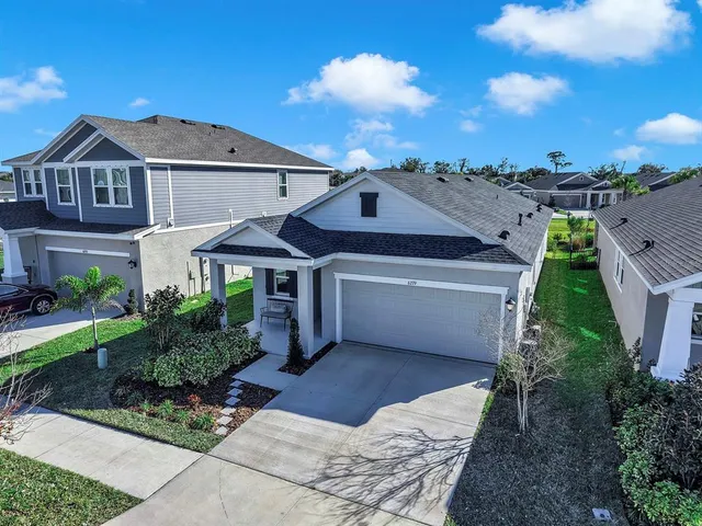 a aerial view of a house next to a yard