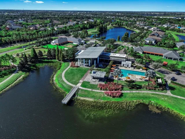 an aerial view of a house with yard swimming pool and outdoor seating