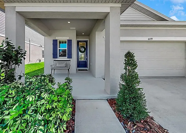 a entryway to the house with potted plants