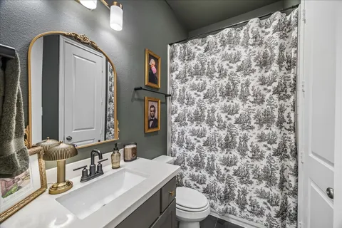 a bathroom with a sink toilet and mirror