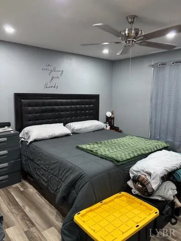 a bedroom with a bed and ceiling fan