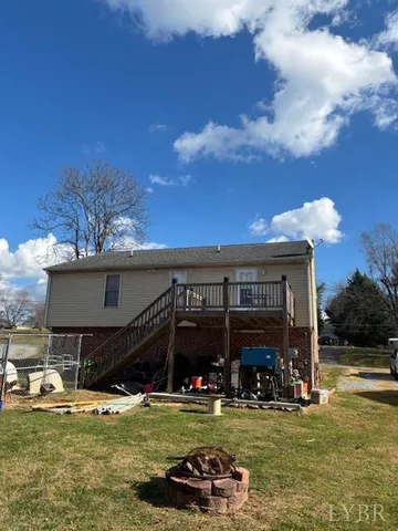 a view of a swimming pool with lawn chairs under an umbrella