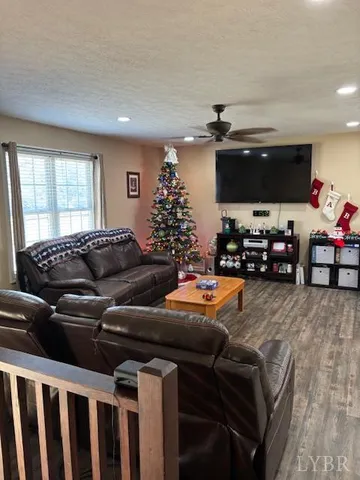 a living room with furniture a flat screen tv and a window