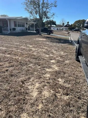 a view of a yard with plants and brick walls