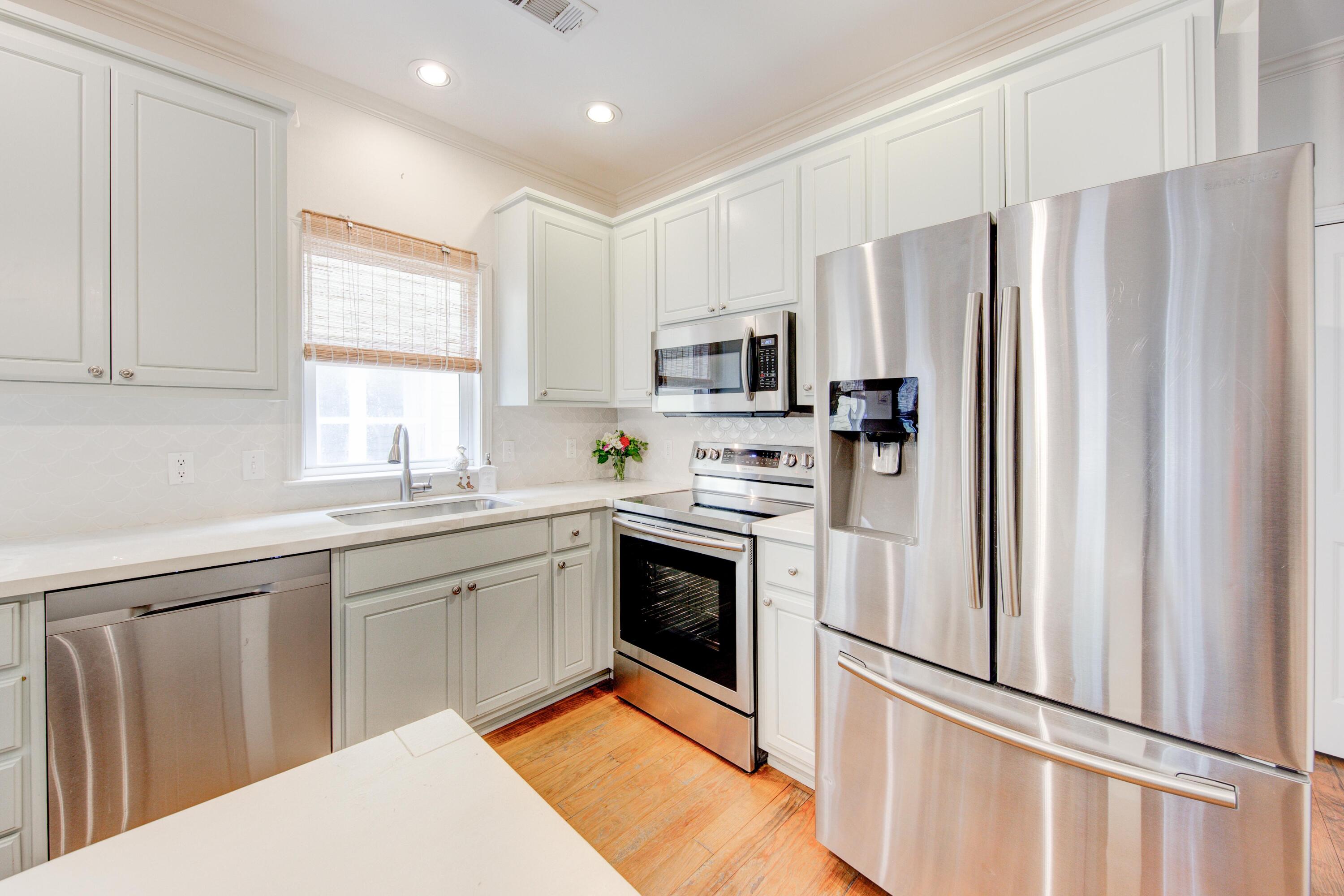 75 Hidden Lake Way Santa Rosa Beach, FL 32459 - Photo 8 of 49 a kitchen with stainless steel appliances a refrigerator sink and microwave