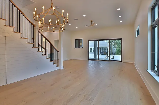 a view of a room that has a dresser and a mirror in it