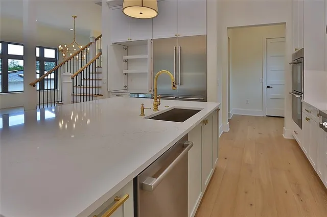 a bathroom with a double vanity sink toilet and shower