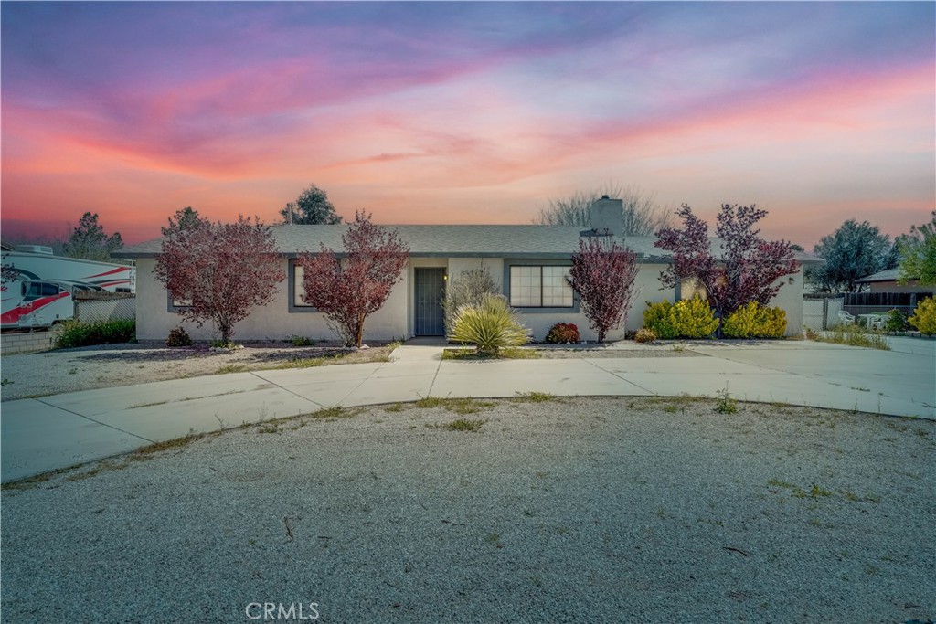 11619 Cibola Road Apple Valley, CA 92308 - Photo 1 of 1 a front view of a house with a yard and road