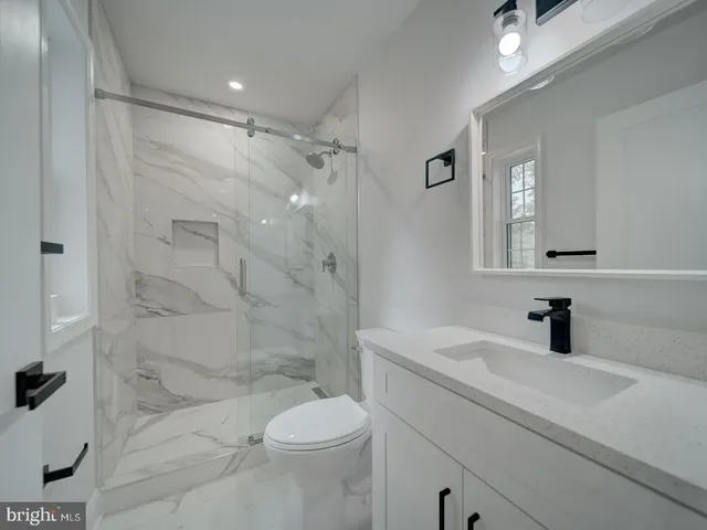 a bathroom with a sink toilet tub and shower