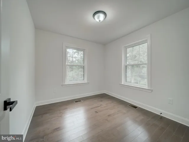 an empty room with a empty space and windows