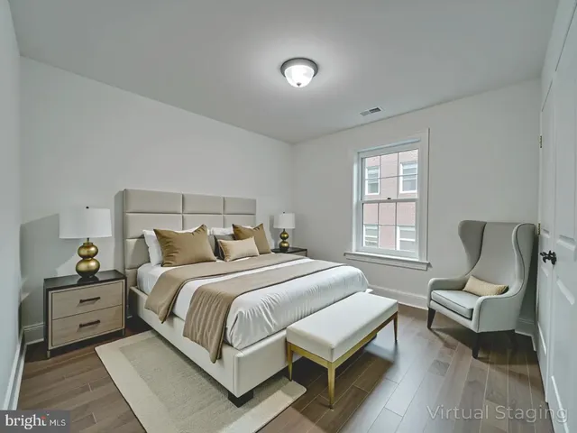 a view of a patio with couches table and chairs under an umbrella