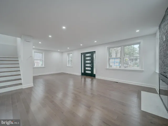 a large kitchen with a table and chairs