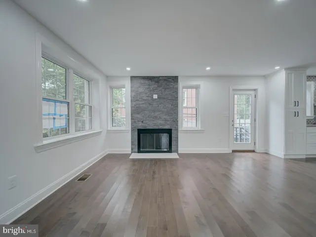 a kitchen with stainless steel appliances granite countertop a refrigerator a sink dishwasher a stove and a refrigerator