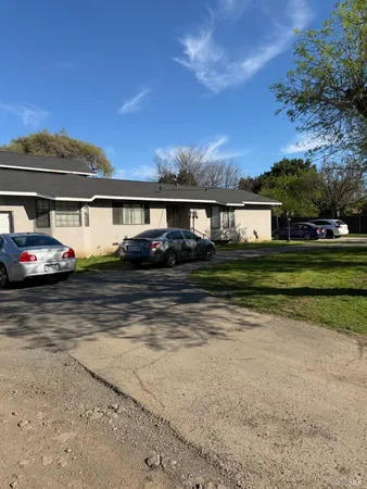 a front view of house with yard and lake view