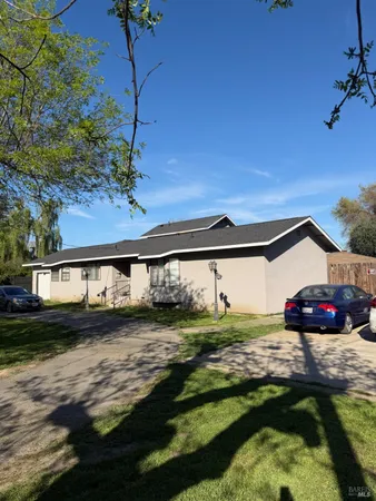 a view of a house with a yard