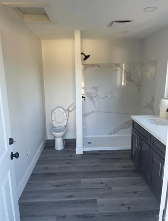 a bathroom with a sink double vanity mirror and a bathtub