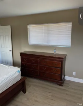 a bedroom with a bed and a dresser