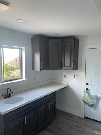 a kitchen with a sink and wooden cabinets