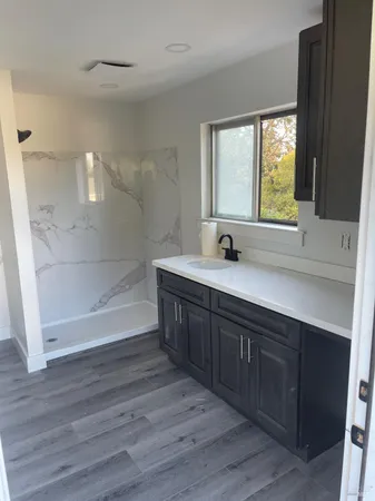 a bathroom with a double vanity sink a mirror and a bathtub
