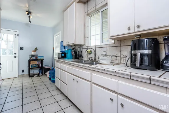 a kitchen with stainless steel appliances cabinets a sink and a window