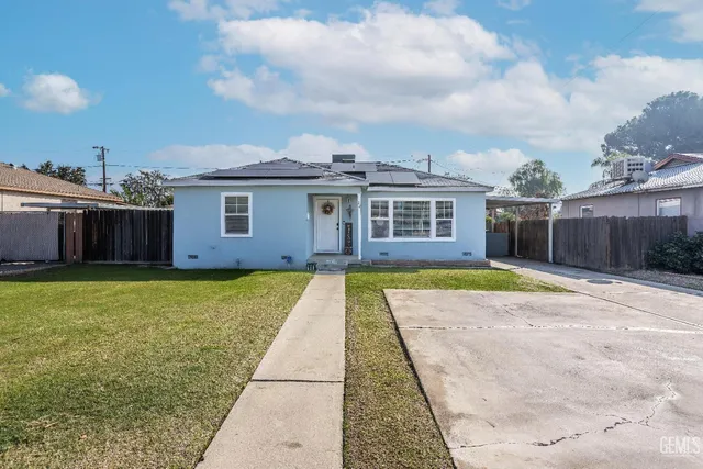 a view of house with yard outdoor seating and barbeque oven