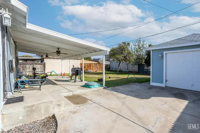 a view of a porch with a table and chairs under an umbrella