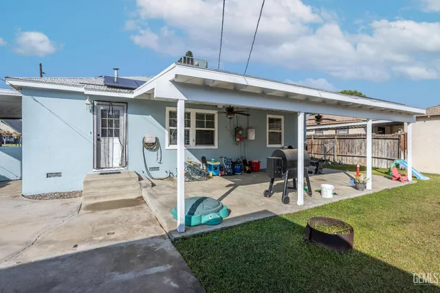 a front view of a house with a yard patio and slide