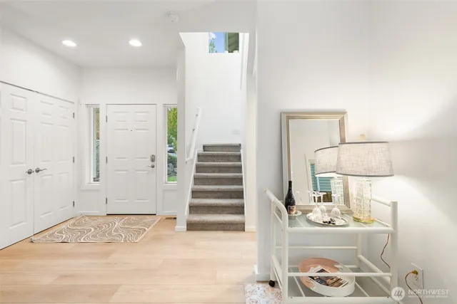 a view of a room with wooden floor and white walls