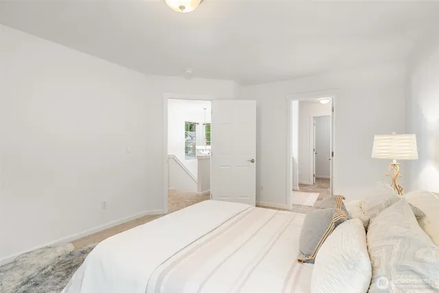 a bedroom with a bed and a lamp