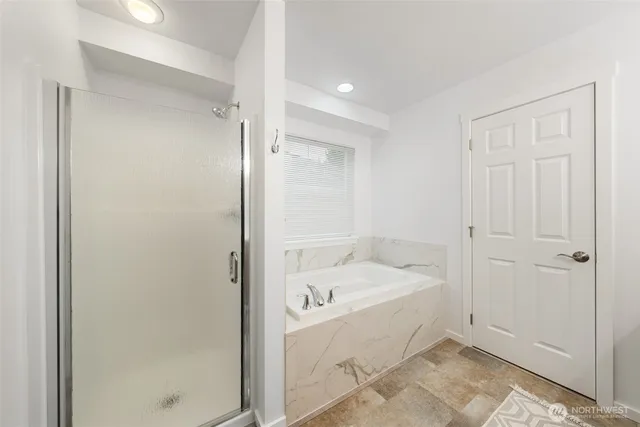 a bathroom with a tub and shower