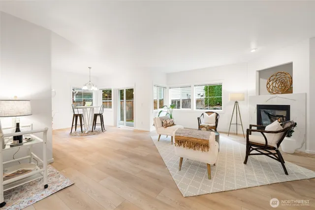 a living room with furniture and a table with potted plants