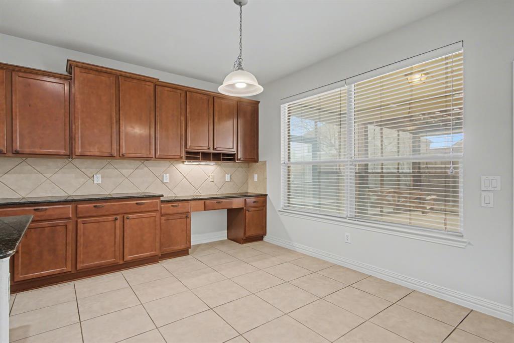 6131 Myrtle Lane Frisco, TX 75036 - Photo 11 of 34 a kitchen with stainless steel appliances granite countertop a sink and cabinets