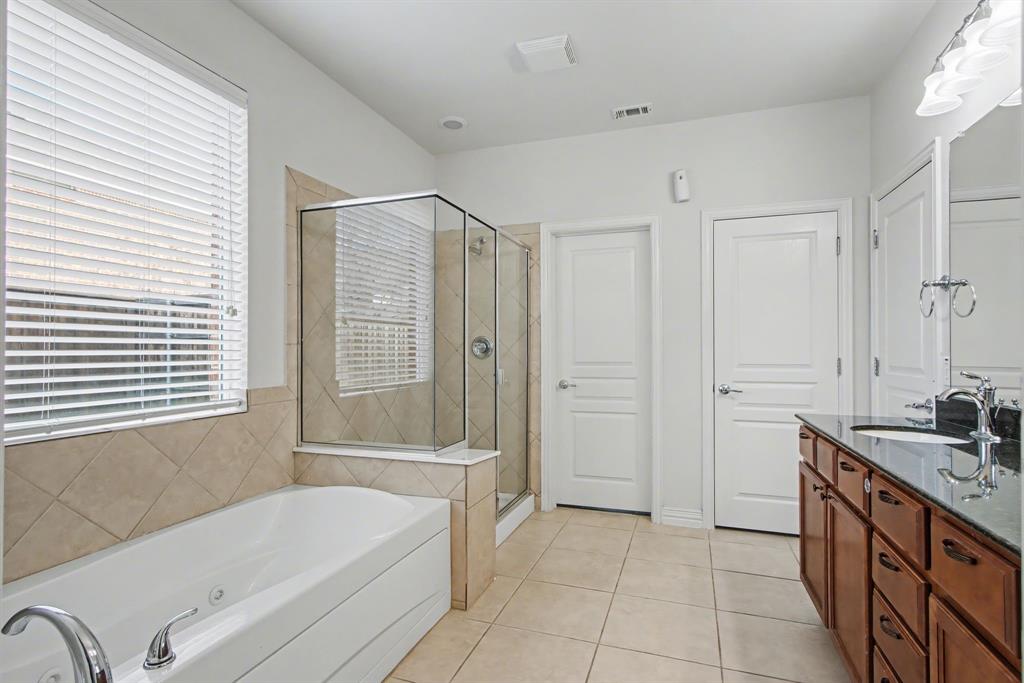 6131 Myrtle Lane Frisco, TX 75036 - Photo 16 of 34 a bathroom with a tub sink and mirror