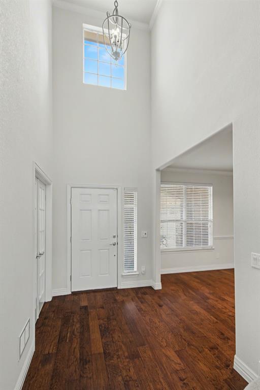 6131 Myrtle Lane Frisco, TX 75036 - Photo 4 of 34 an empty room with wooden floor cabinet and windows
