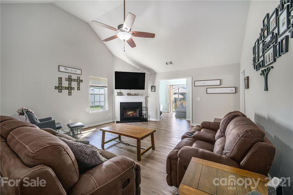 2778 Rustic Ridge Court Rock Hill, SC 29730 - Photo 11 of 34 a living room with furniture a fireplace and a flat screen tv