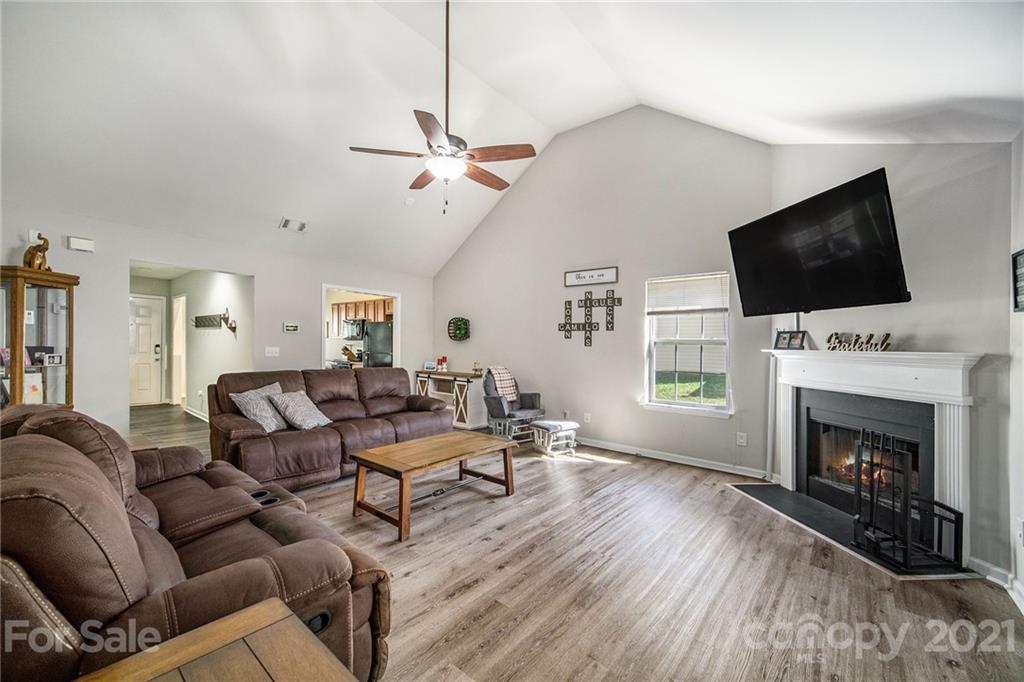 2778 Rustic Ridge Court Rock Hill, SC 29730 - Photo 13 of 34 a living room with furniture a fireplace and a flat screen tv