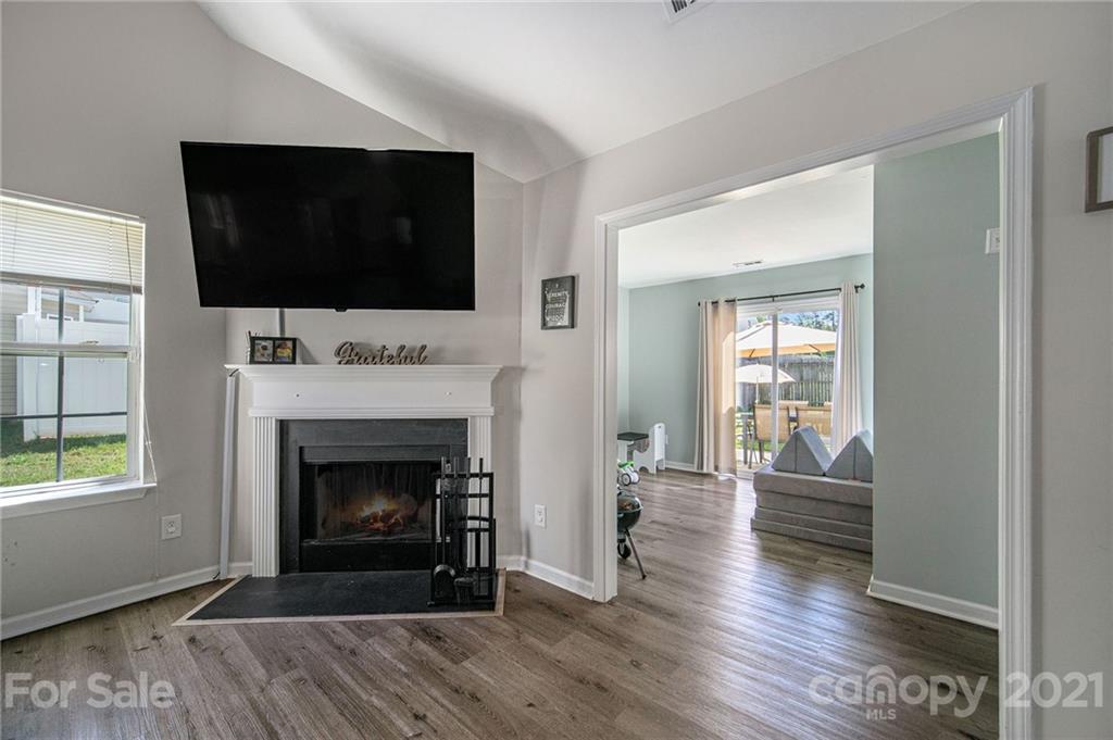 2778 Rustic Ridge Court Rock Hill, SC 29730 - Photo 14 of 34 a living room with a fireplace and a flat screen tv