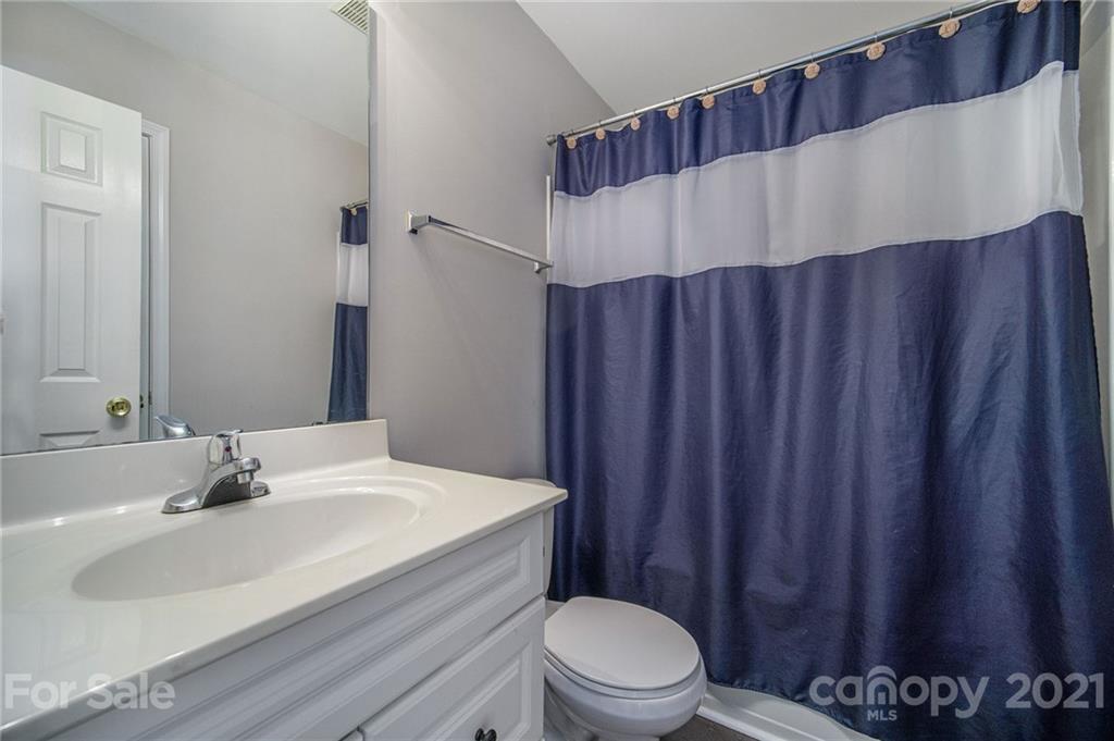 2778 Rustic Ridge Court Rock Hill, SC 29730 - Photo 17 of 34 a bathroom with a sink a toilet and shower curtain