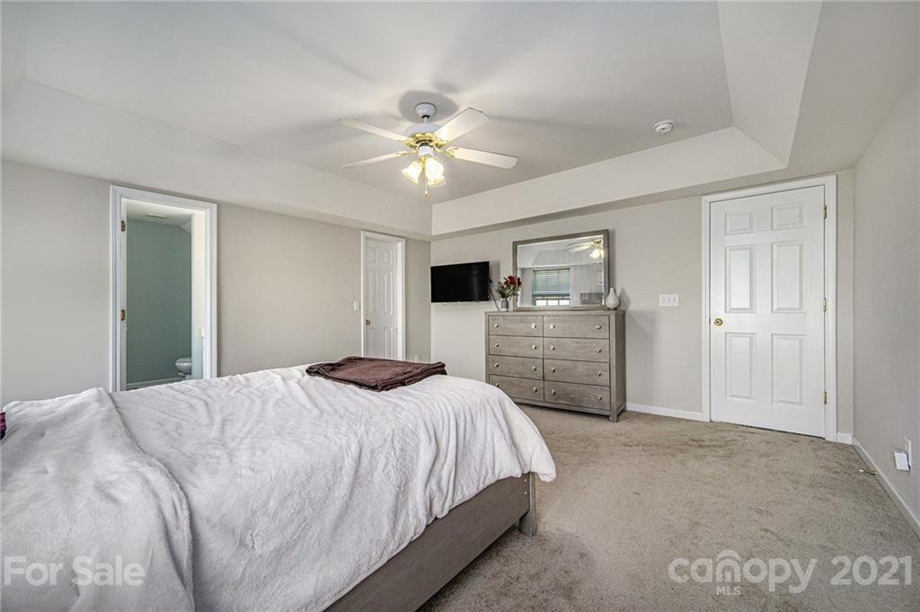 2778 Rustic Ridge Court Rock Hill, SC 29730 - Photo 21 of 34 a bedroom with a bed a dresser and a chandelier