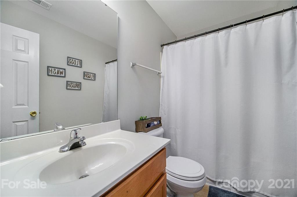 2778 Rustic Ridge Court Rock Hill, SC 29730 - Photo 30 of 34 a bathroom with a sink a toilet and a mirror