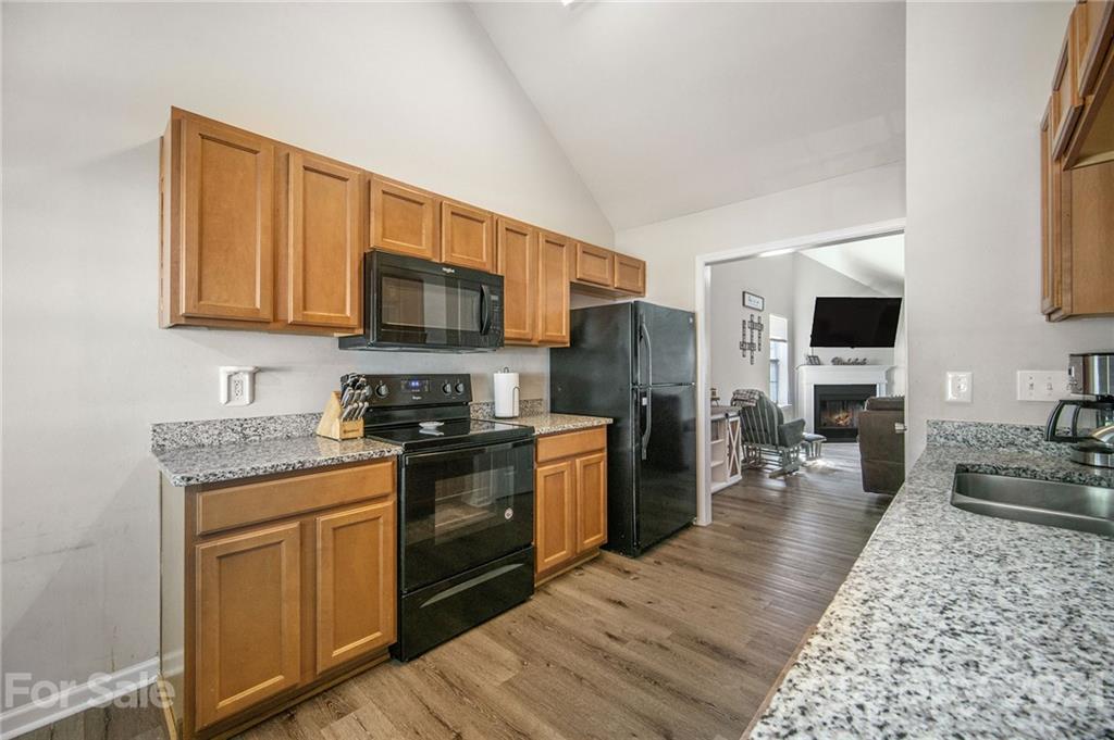 2778 Rustic Ridge Court Rock Hill, SC 29730 - Photo 5 of 34 a kitchen with stainless steel appliances granite countertop a stove top oven a sink dishwasher a refrigerator and a microwave