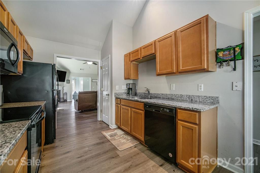 2778 Rustic Ridge Court Rock Hill, SC 29730 - Photo 8 of 34 a kitchen with granite countertop a sink cabinets and stainless steel appliances